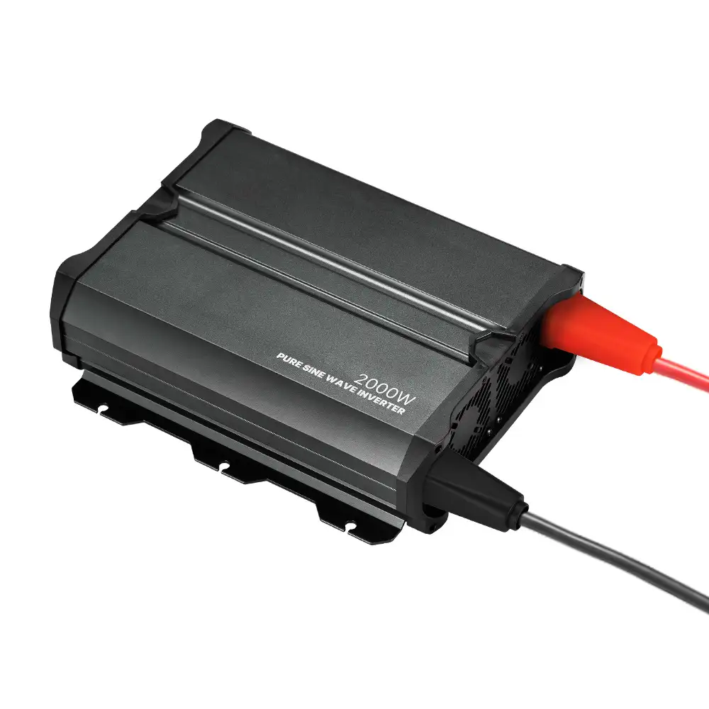 This dark gray 2000w Pure Sine Wave Inverter displays its "2000W" label, side cooling vents, and connected red and black input cables.