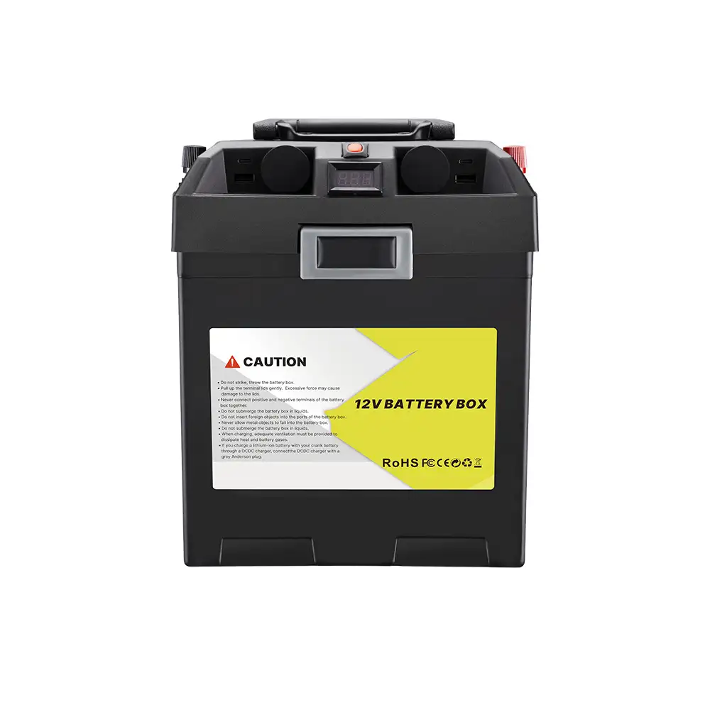 A black Compact 12V Battery Box with PD30W Multi-Port DC Output displays its top digital readout and prominent yellow 'CAUTION' warning label.